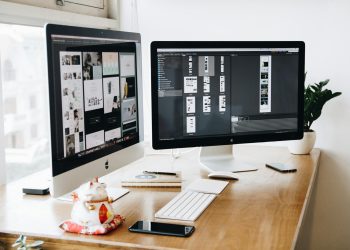 A well-organized design workspace with dual monitors and design software on display.