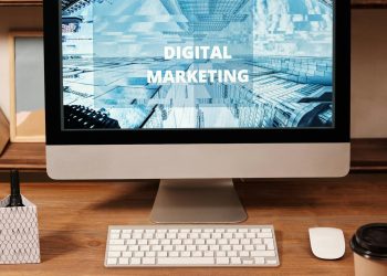 Contemporary office setup featuring digital marketing strategy on a computer screen, ideal for business technology themes.
